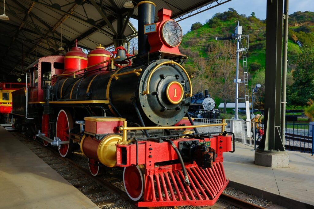 A classic steam locomotive displayed in an outdoor railway museum setting.